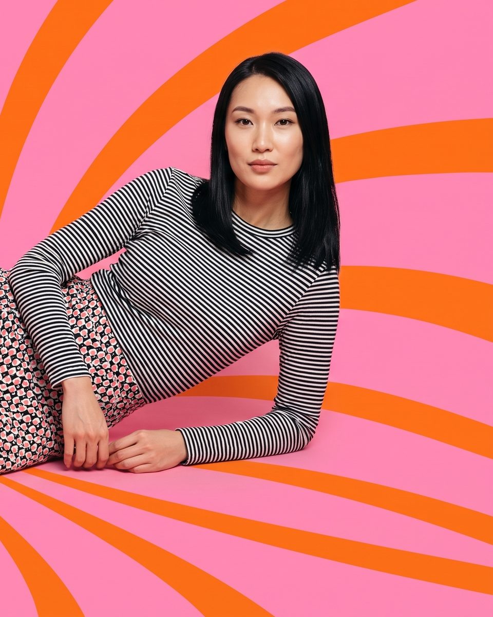 Pop-art portrait reclining on a pink and orange swirl backdrop